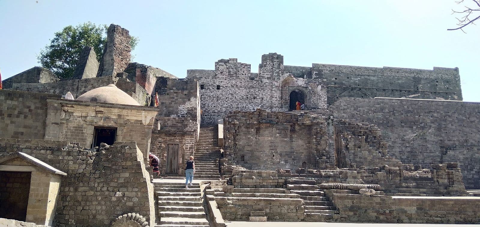 Stone ramparts, stairways and temple ruins inside the ancient Kangra Fort