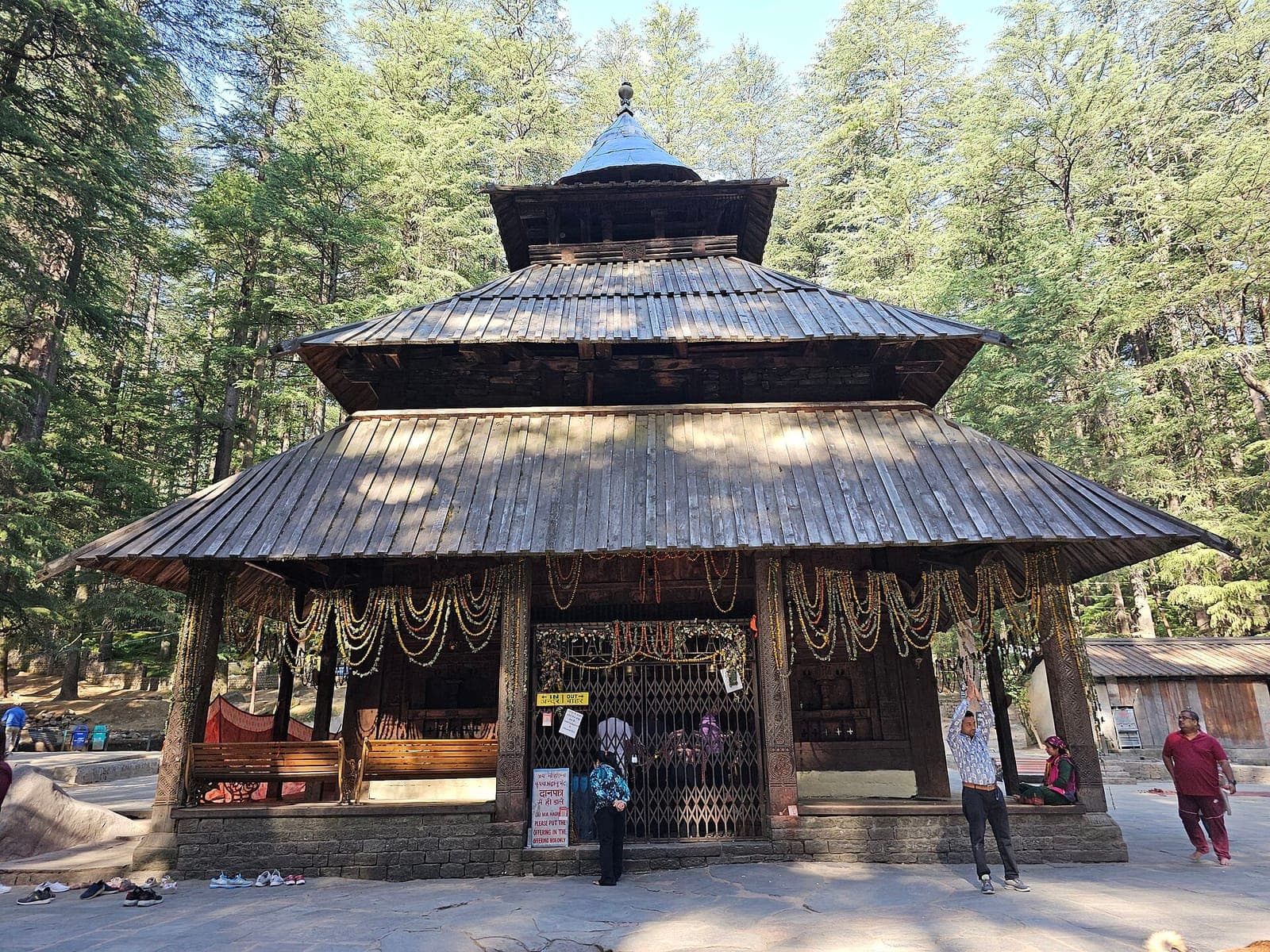 The wooden Hadimba Devi temple with its tiered roofs among deodar trees in Dhungri, Manali