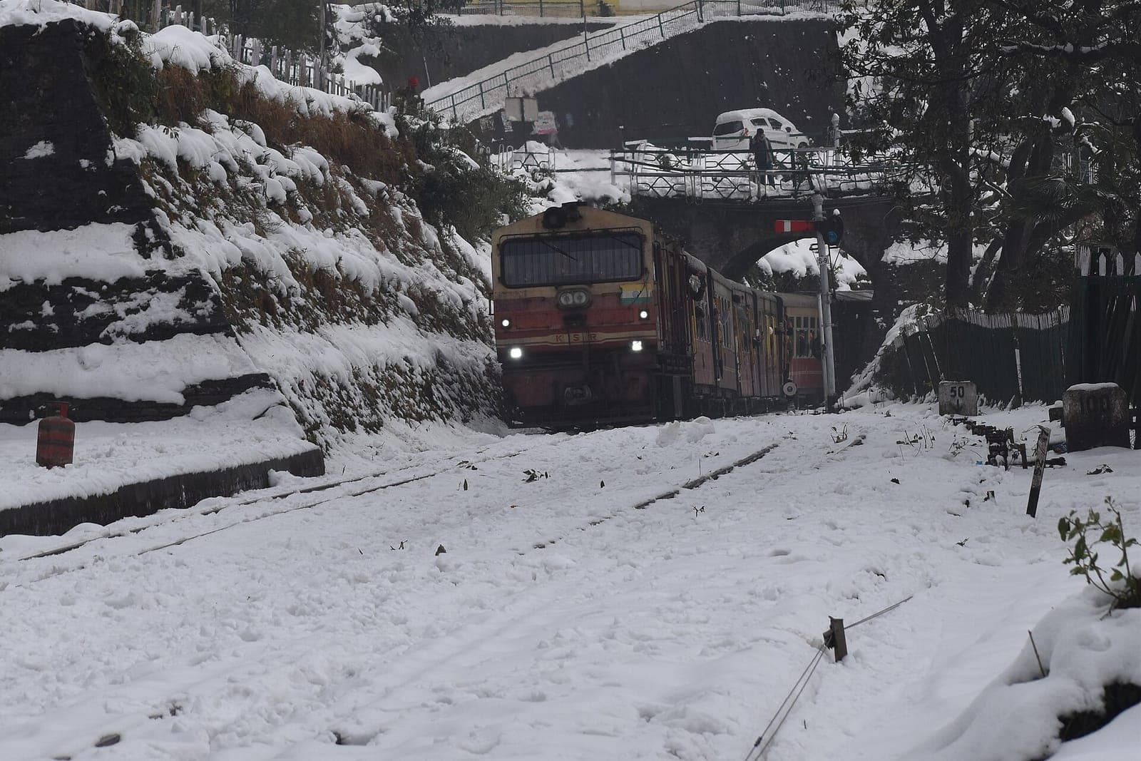 The Kalka-Shimla toy train arriving at Summer Hill station in fresh snow, Shimla