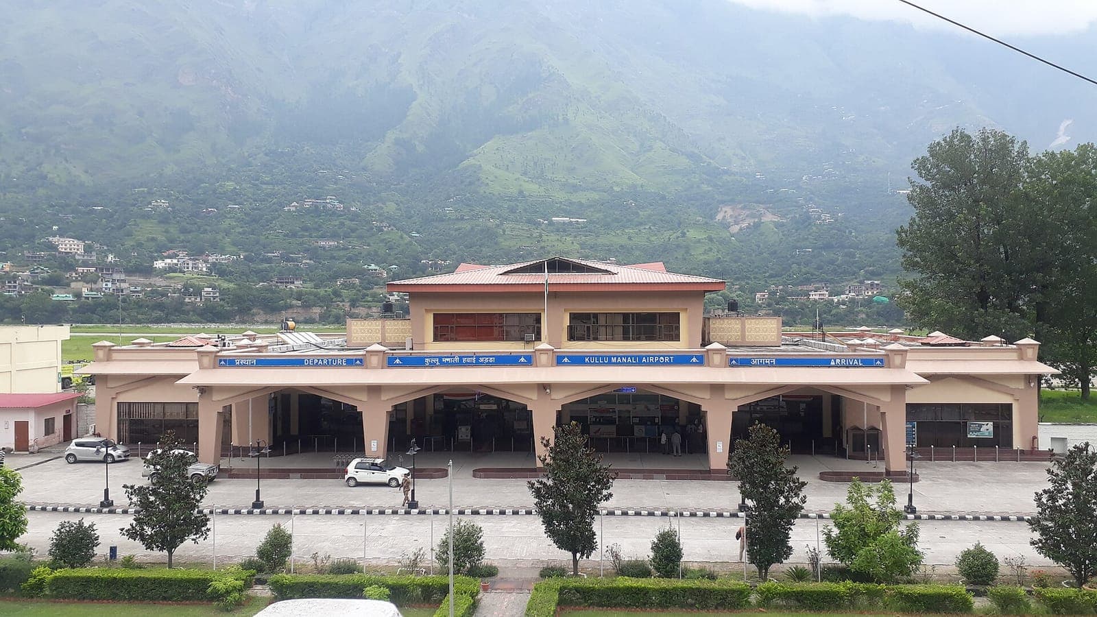 Kullu-Manali Airport terminal at Bhuntar with green hills of the Kullu valley behind