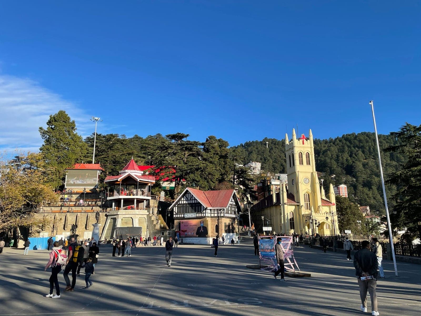The Ridge in Shimla on a sunny day, with Christ Church, the Tudor library and visitors strolling