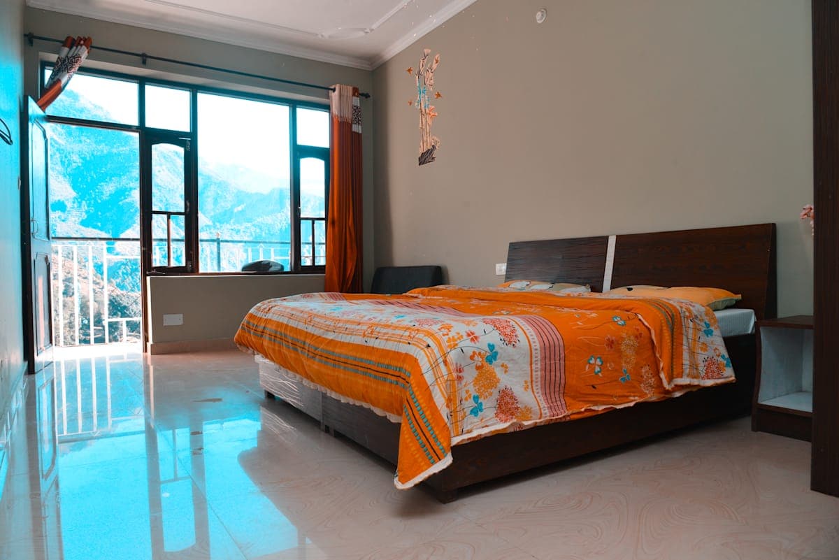 Private double room with mountain-view windows at Backpackers Inn, McLeod Ganj