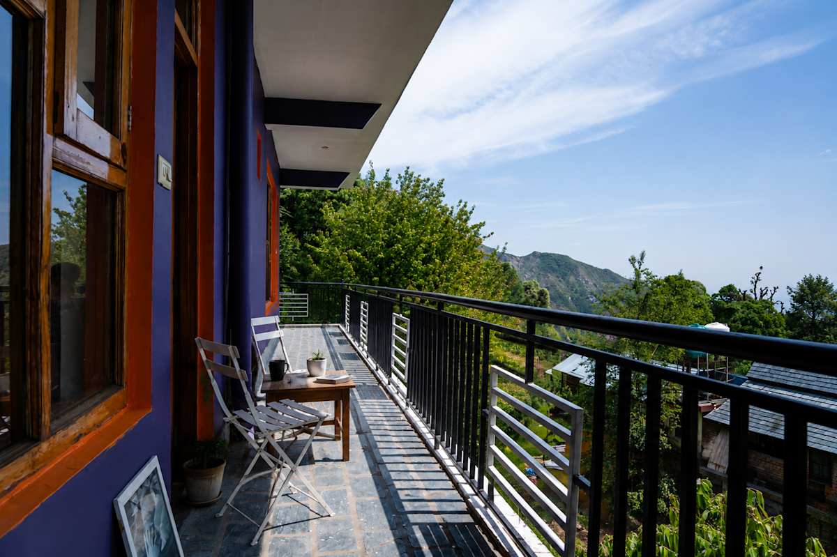 Balcony with seating and valley view at Loopin McLeodganj, Upper Bhagsunag