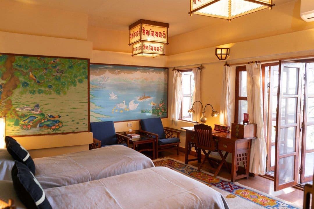 Themed guest room with lake and bird murals at Chonor House, McLeod Ganj