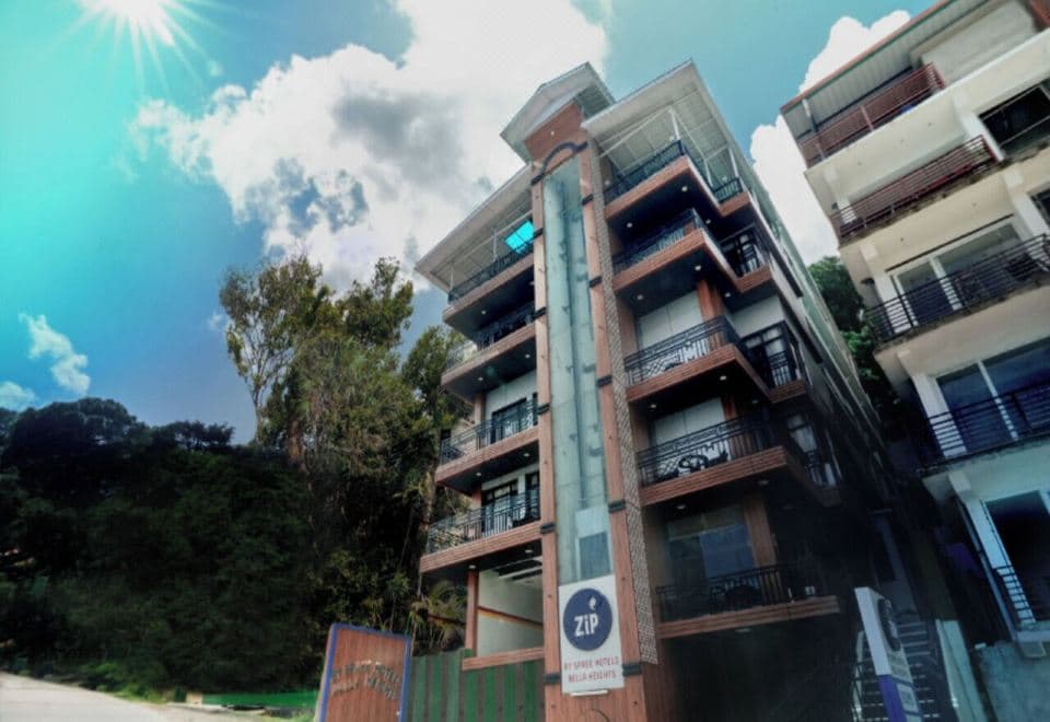 Hotel Bella Heights, a tall building with balconies and Zip signage on Temple Road, McLeod Ganj