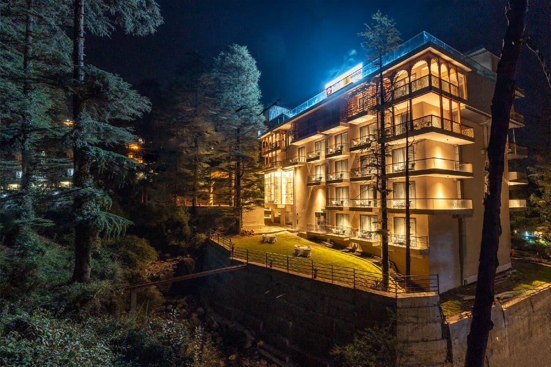 Mastiff Select Mandavya lit up at night among the deodars, Dharamkot