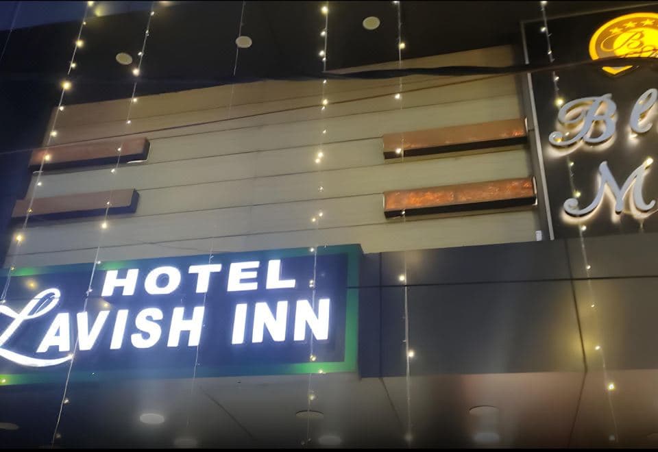 Illuminated Hotel Lavish Inn sign on the building front, Jogiwara Road, McLeod Ganj