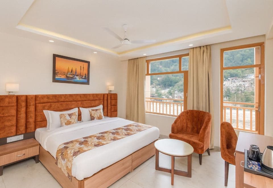 King room with wood-framed windows and a hillside view at Hotel Pawan Regency, Jogiwara Road, McLeod Ganj