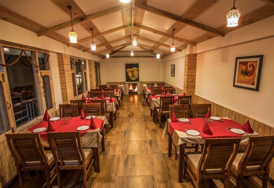 Restaurant with fireplace at The Lodge Dharamkot
