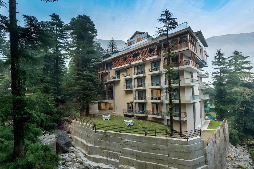 Mastiff Select Mandavya hotel building on the forested hillside, Dharamkot