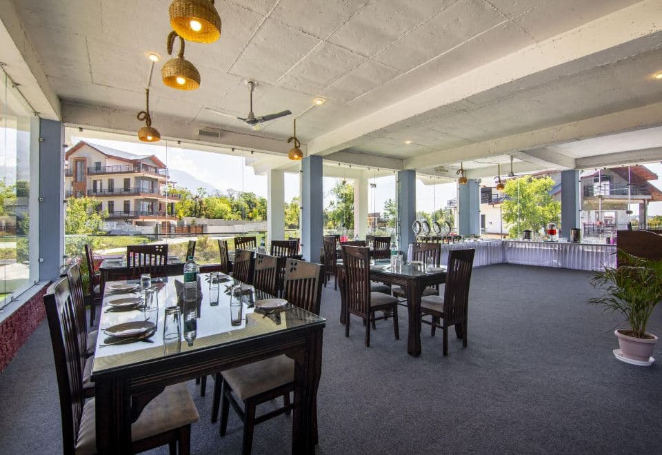 Rooftop restaurant with mountain views at Treebo Ortus Residency