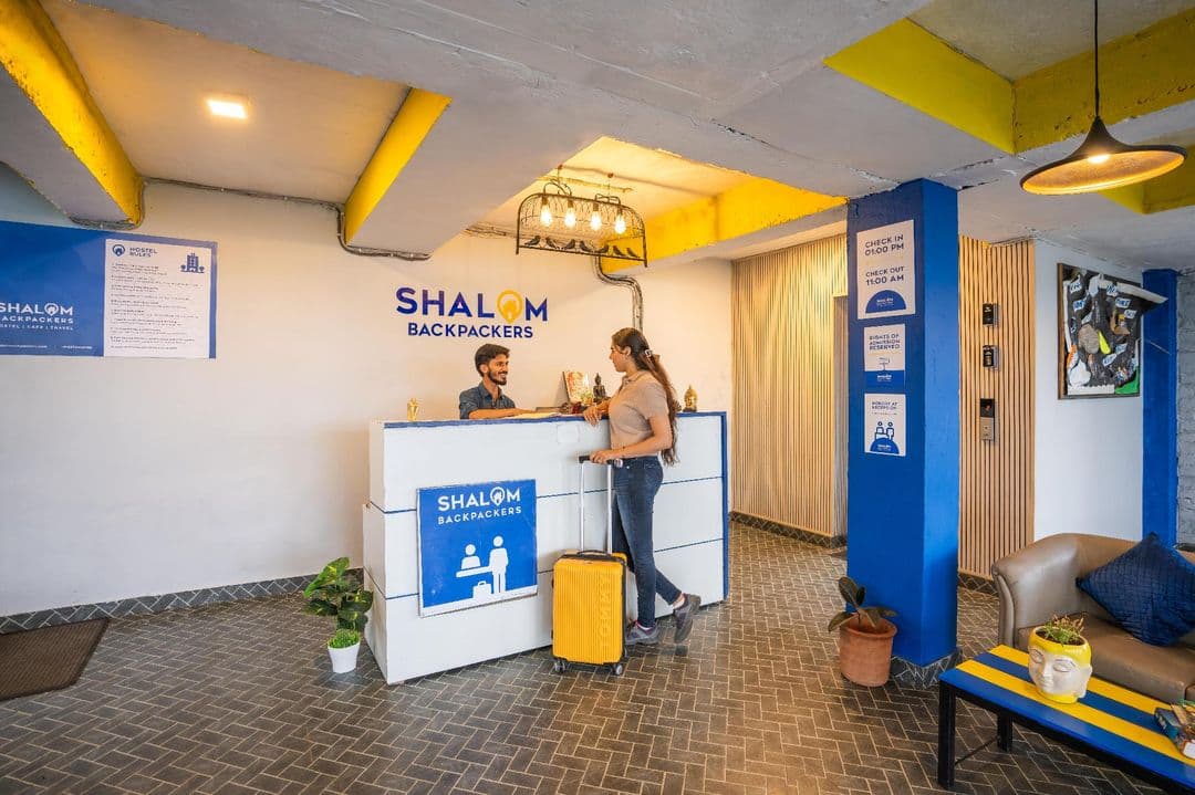 Reception desk with Shalom Backpackers sign, Upper Dharamkot