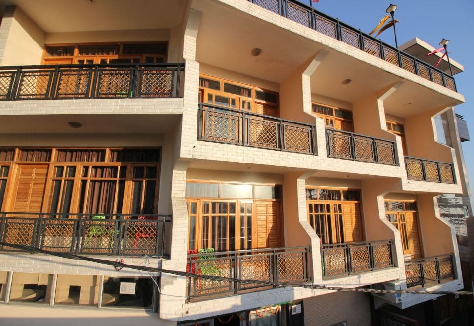 Hotel Asian Plaza balconies with wooden shutters above the Main Square, McLeod Ganj