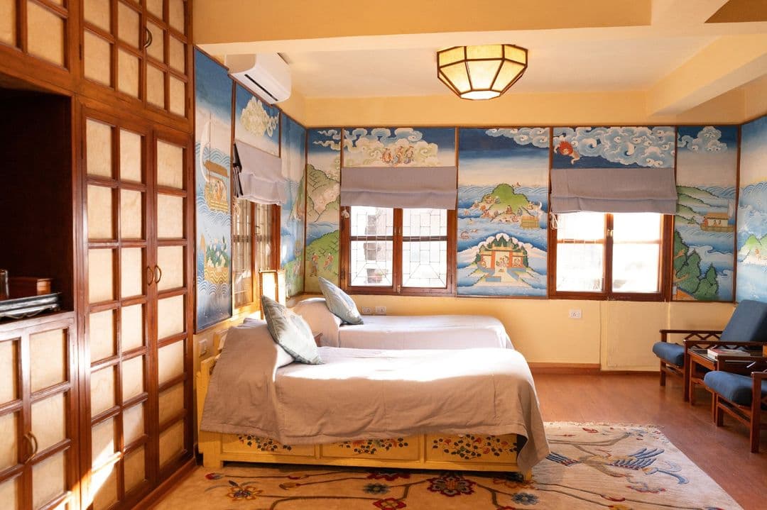 Twin room decorated with Tibetan landscape murals at Chonor House
