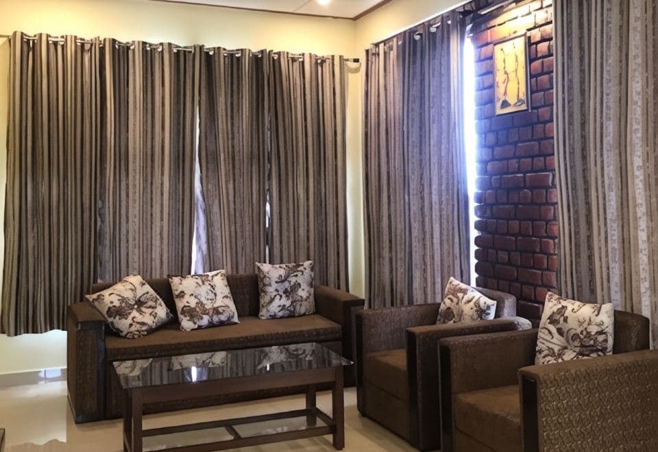 Sitting area with sofas and an exposed-brick feature wall at The Sojourn