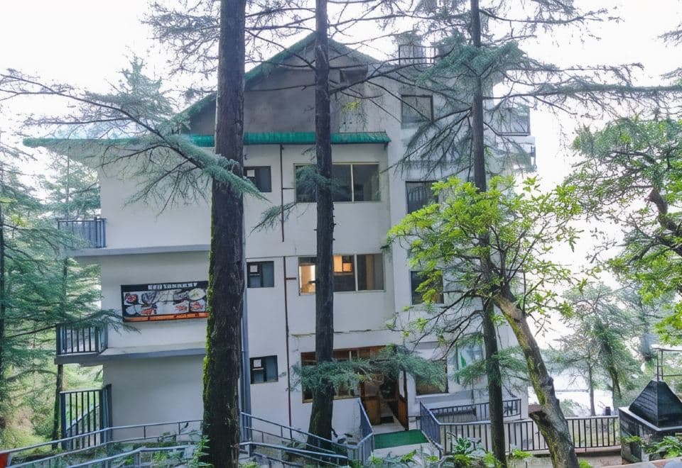 White Water Inn seen from below through the forest, Dharamkot Road