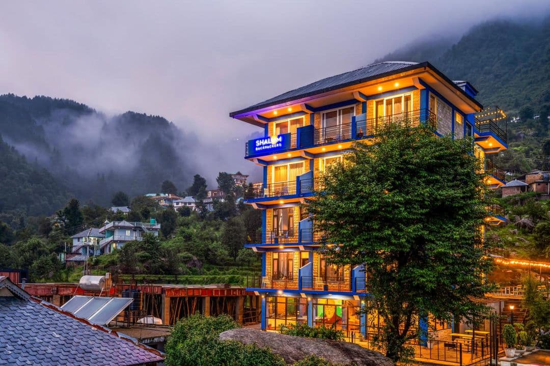 Shalom Backpackers Dharamkot with misty Dhauladhar slopes behind