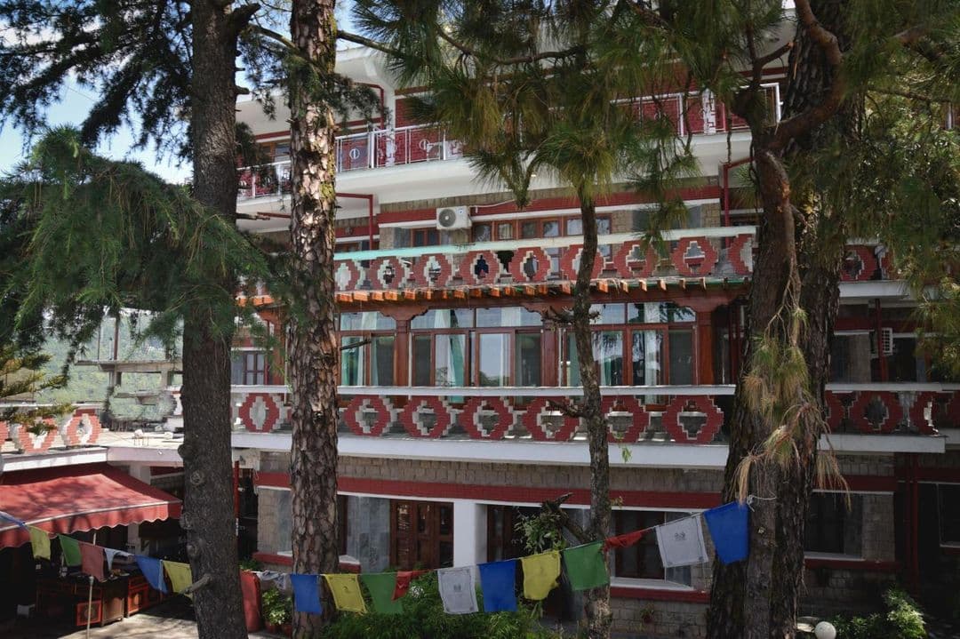 Balconied facade of Chonor House seen through the cedar trees, Temple Road