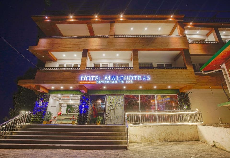 Hotel Malghotras restaurant and bar facade lit at night, Naddi Road, McLeod Ganj