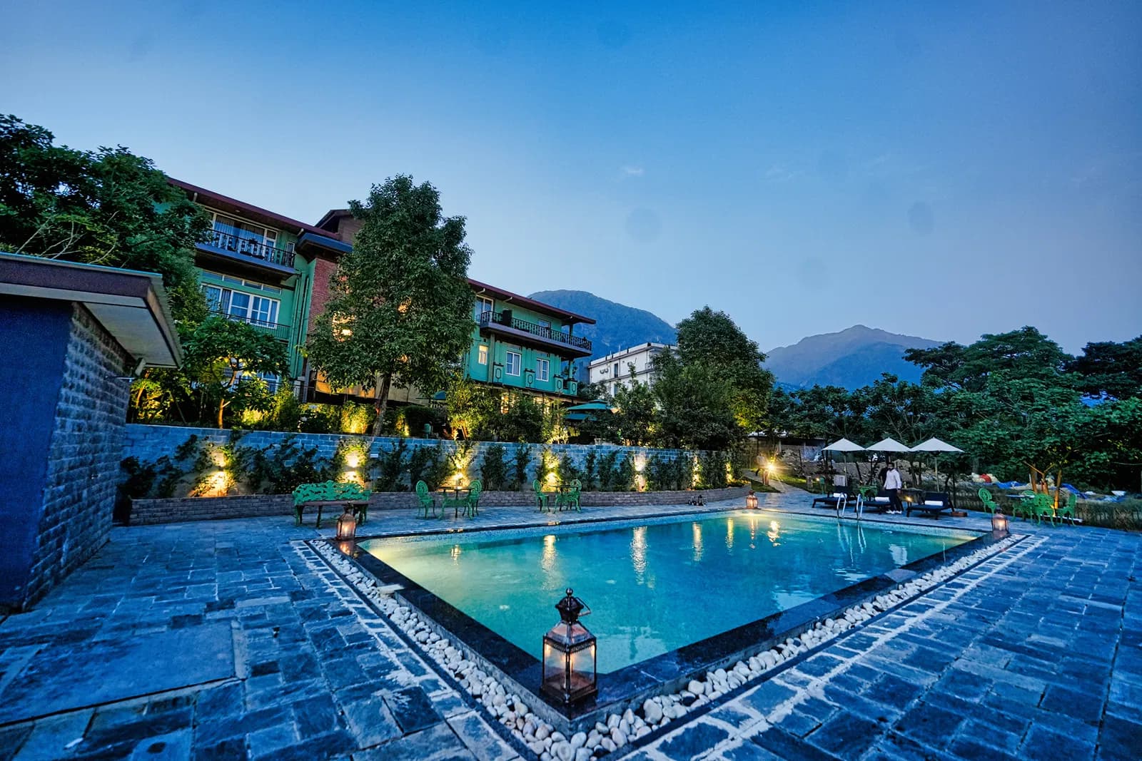 Swimming pool with mountain backdrop at Atman, Dharamshala