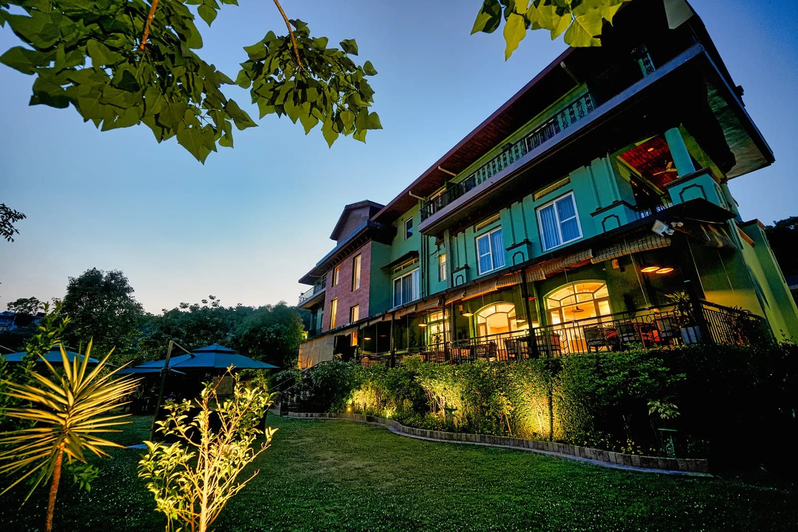 Stone-and-timber building and lawns at Atman, Dharamshala