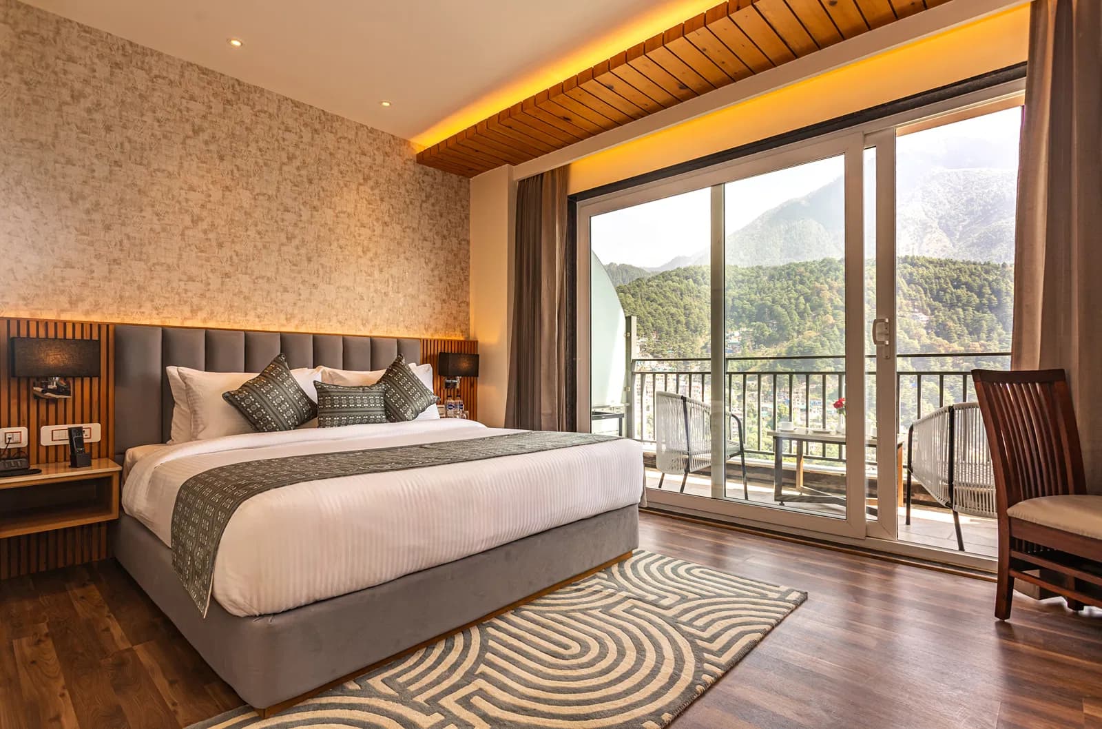 Suite bedroom with balcony and mountain view at The Belvedere Himalayan Retreat, McLeod Ganj