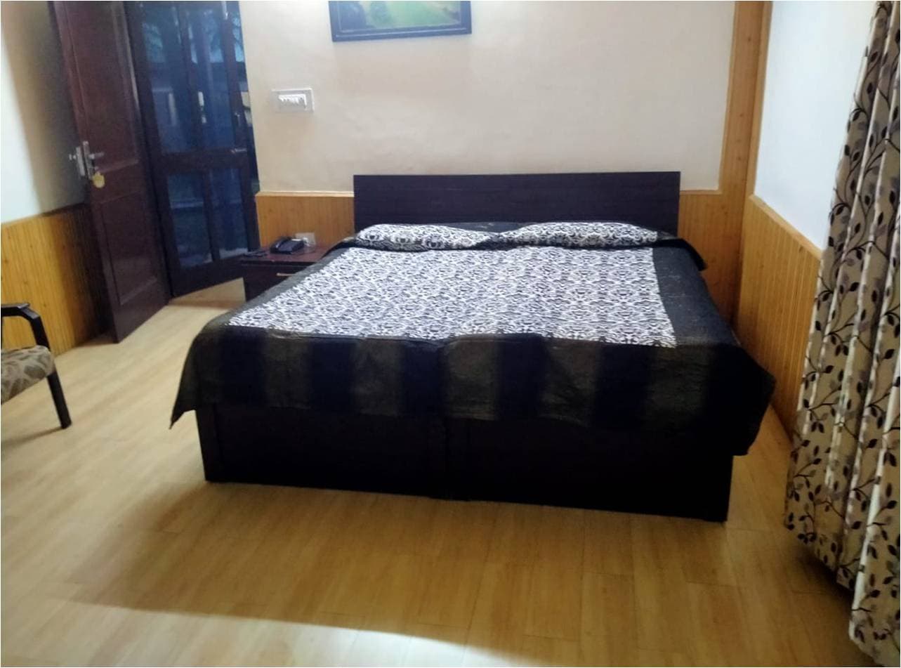 Deluxe room with wooden floor at HPTDC Hotel Bhagsu, McLeod Ganj