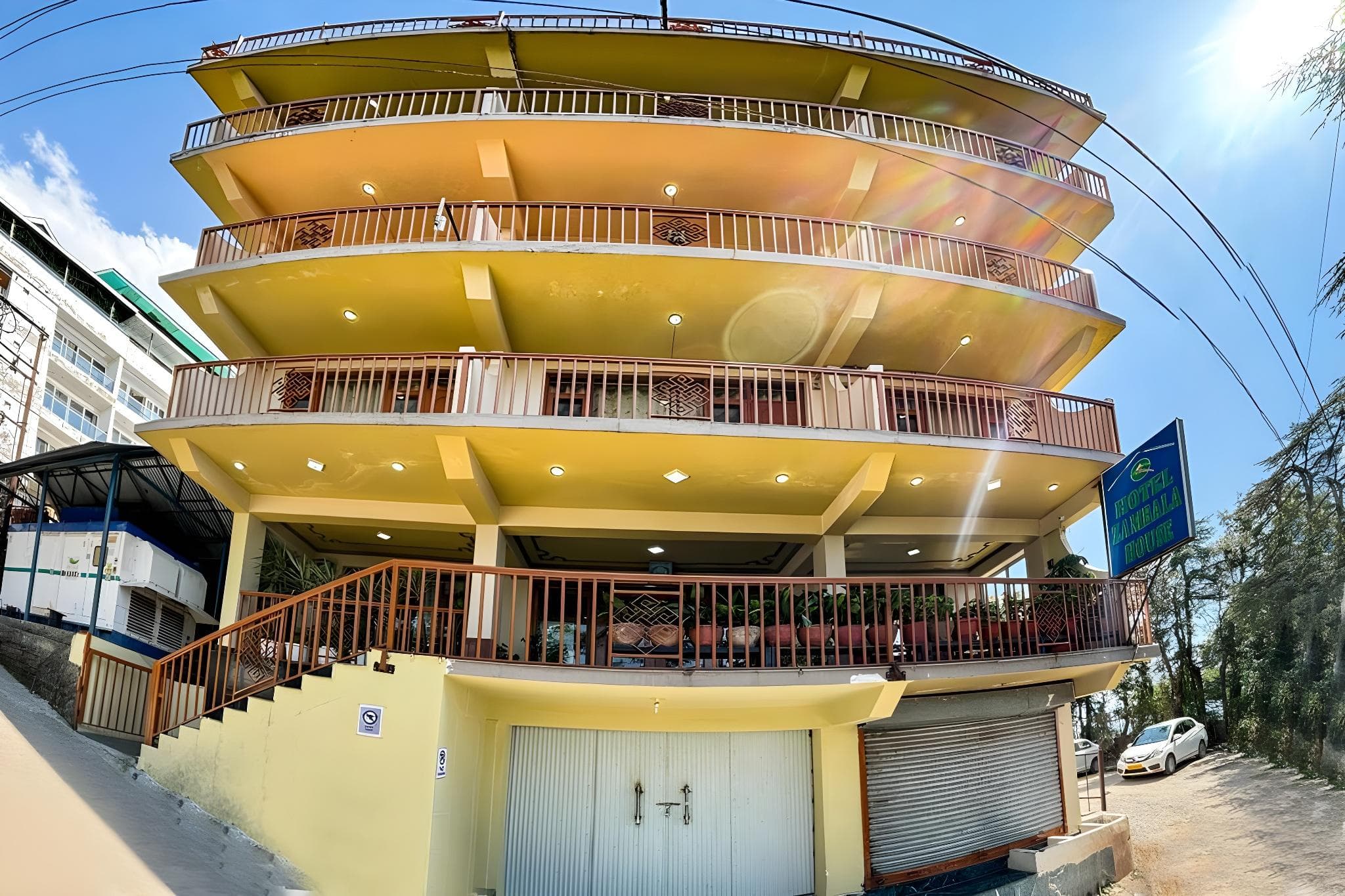 Zambala House, a cream building with wide balconies at the end of Himachal Tourism Road, McLeod Ganj