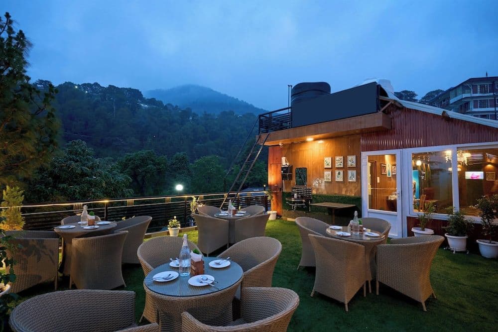 Terrace dining at dusk at Treebo Roshan House