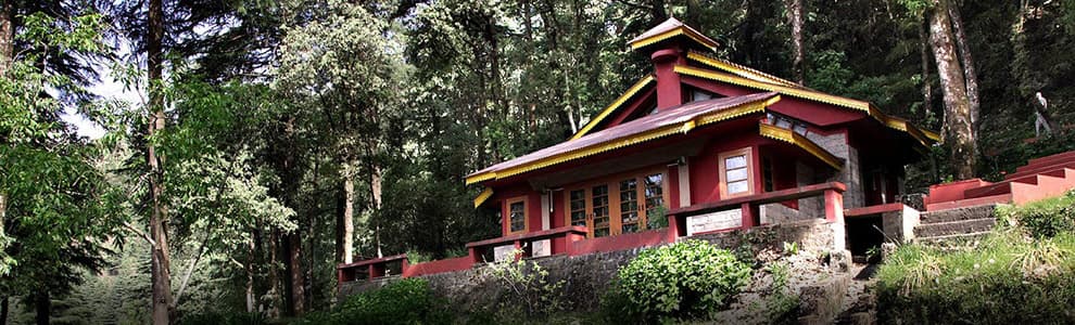 Cottage with red trim in the deodar forest at Glenmoor Cottages