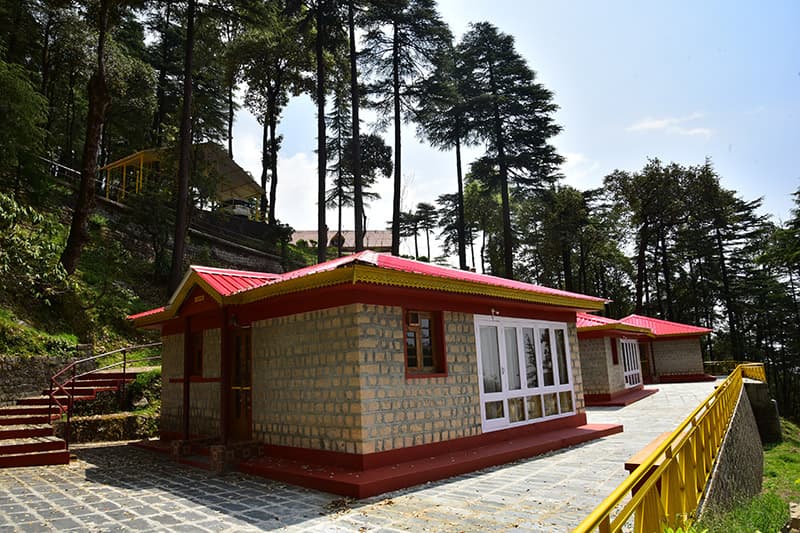 Stone cottage with glazed verandah at Glenmoor Cottages, McLeod Ganj