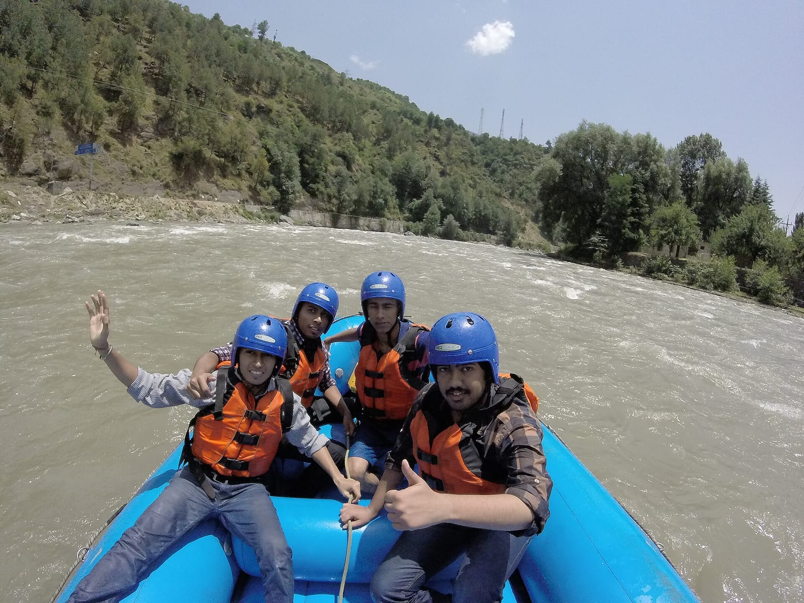 Tourists in life jackets rafting on the Beas river in Kullu, Himachal Pradesh