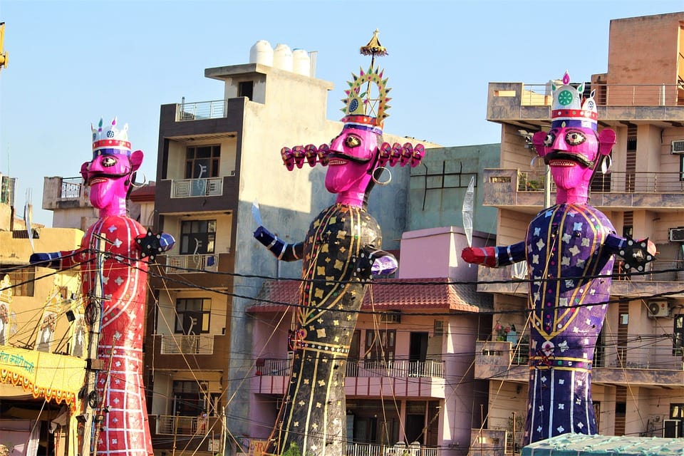 Tall colourful effigies of Ravan, Meghnad and Kumbhkaran standing ready for Dussehra