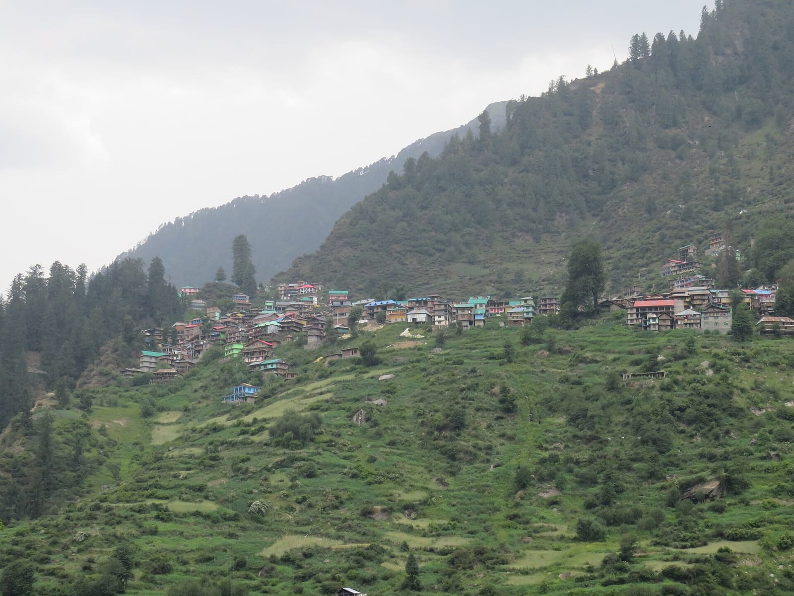 Malana village and its terraced fields on a slope in the Malana valley, Kullu district