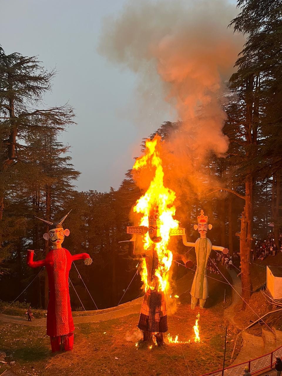 Ravan, Meghnad and Kumbhkaran effigies burning among deodar trees at the Dussehra celebration at Jakhu Temple, Shimla