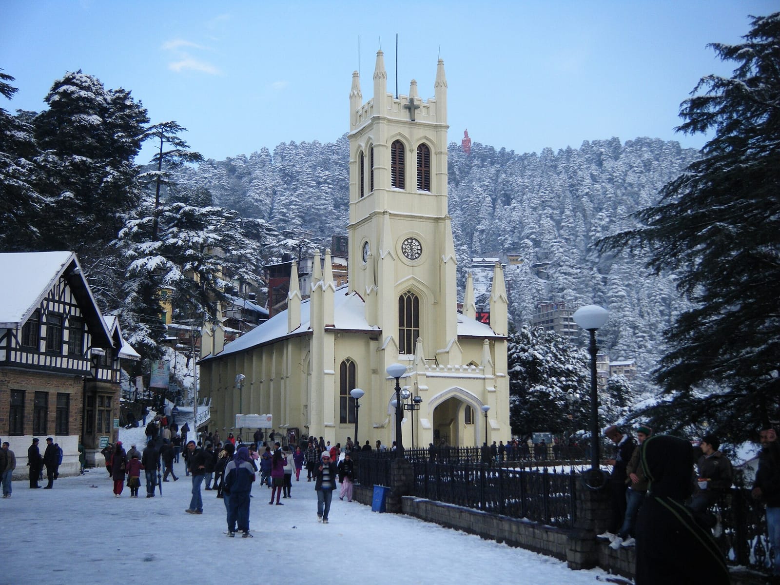 Christ Church on the Ridge in Shimla after a snowfall, with snow on the ground and on the deodar trees